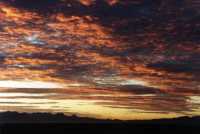 sunrise on altocumulus over mountains