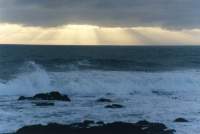 sunbeams at dusk off coast at Sea Point
