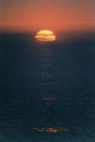 sunset zoom over waves off Sea Point