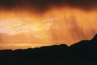 sunset clouds with rain virga over Table Mountain