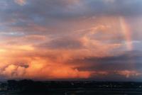 sunset on cumulonimbus with rainbow