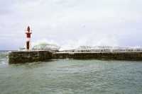 Kalk Bay harbour breakwater with wave splash